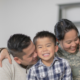 Military family hugging with Army mom in the middle